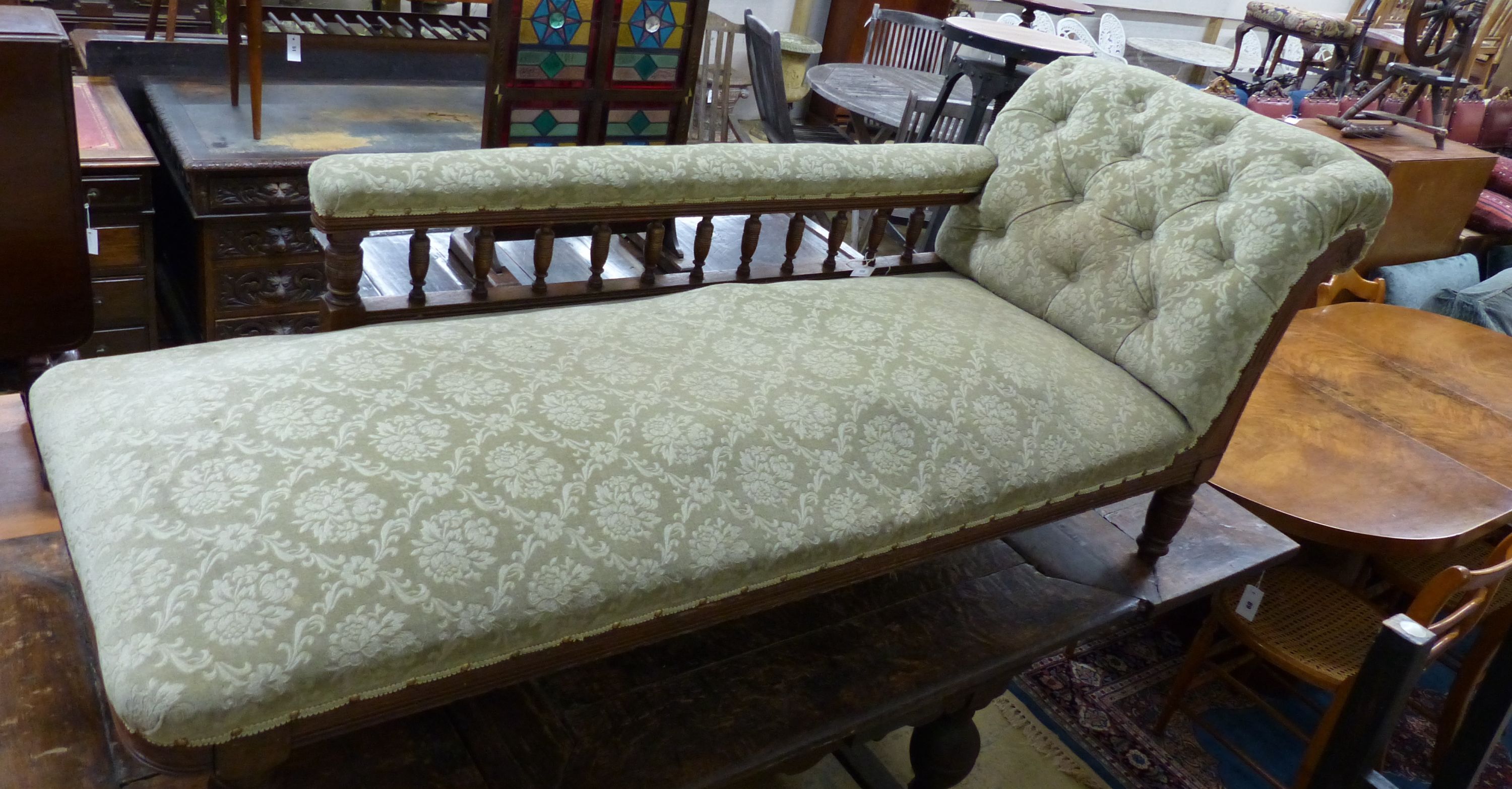 An Edwardian oak chaise longue